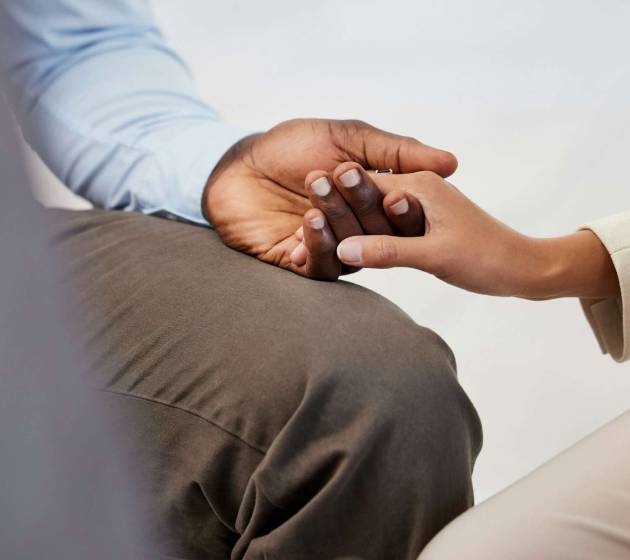 Hand holding, support and care of friends or group therapy people for cancer or drug addiction. He